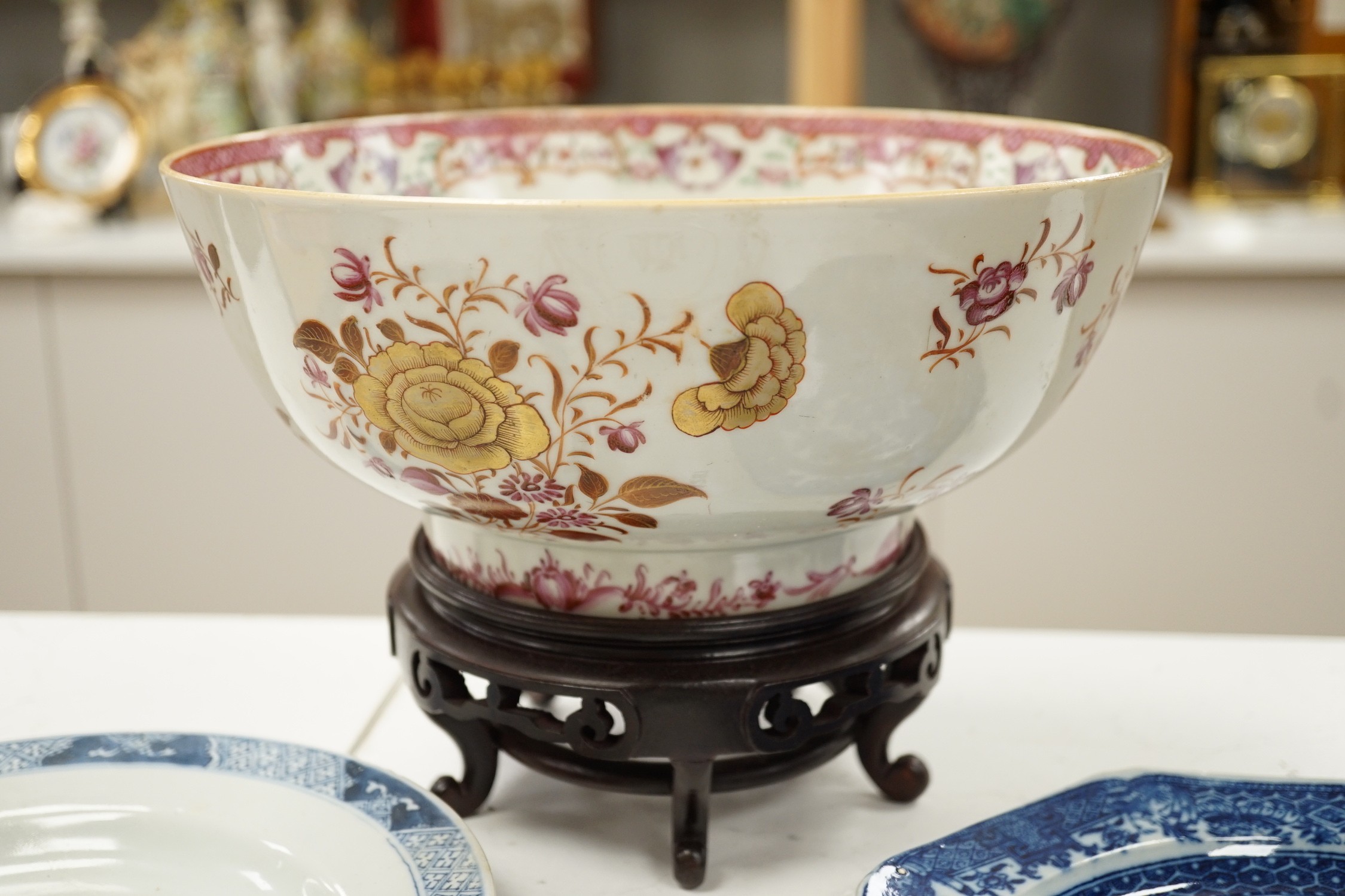 A Chinese export armorial soup plate, for the Spanish market, Qianlong period, with a Spanish coat of arms, possibly Aguado de Las Marismas, an 18th century Chinese export punch bowl on stand, a Chinese blue and white pl